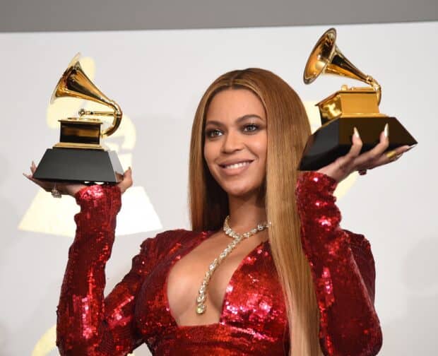 (FILES) Singer Beyonce poses with her Grammy trophies in the press room during the 59th Annual Grammy music Awards on February 12, 2017, in Los Angeles, California. Beyonce is the most decorated artist in Grammys history, and her album releases have both triggered cultural earthquakes and reshaped music industry norms. But few artists have ever been snubbed so conspicuously by the Recording Academy -- for all her trailblazing accomplishments, Beyonce has never won the prestigious prizes for best album or record. Once again on Sunday, she will head to the Grammys gala with the most chances to win, after "Cowboy Carter" -- her genre-spanning, sociopolitically charged conversation piece of an album -- dropped last spring to critical acclaim. (Photo by Robyn BECK / AFP)