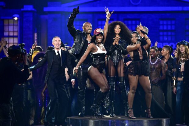 US rappers Doechii (3L) and JT (R) perform with Canadian fashion designers Dean (L) and Dan (2R) Caten, British super model Naomi Campbell (4L) and US model and actor Tyson Beckford (2L) after the presentation of a creation by Dsquared2 for the Womenswear Ready-to-wear Fall-Winter 2025/2026 collection as part of the Milan Fashion Week, in Milan on February 25, 2025. (Photo by Piero CRUCIATTI / AFP)