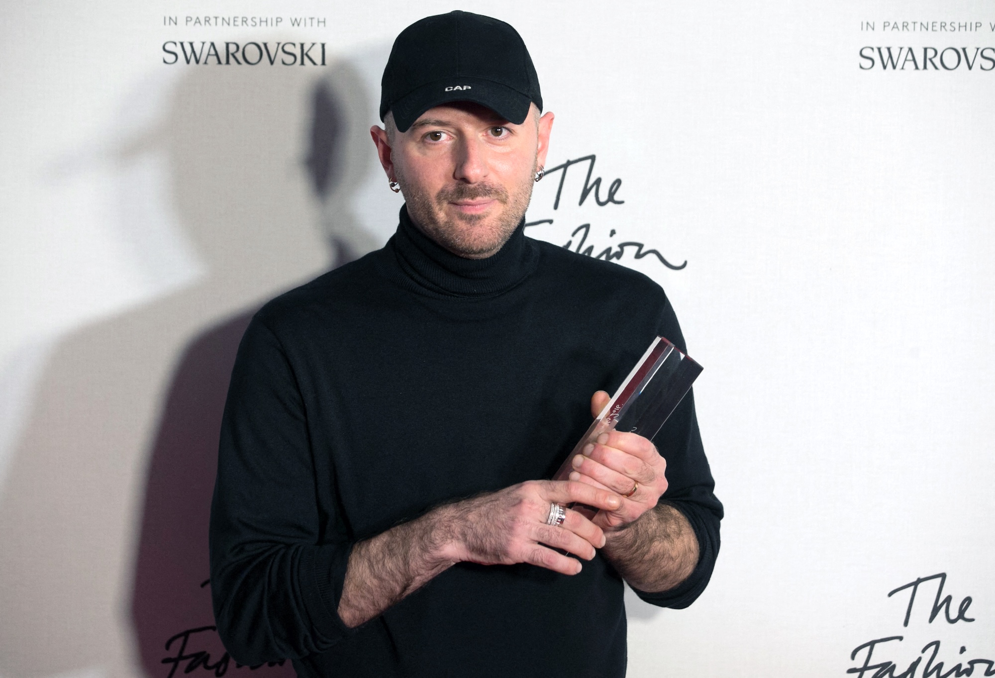 (FILES) Designer Demna Gvasalia of fashion house Balenciaga poses with his award after being named winner of the International Ready-to-Wear Designer award during the British Fashion Awards 2016 in London on December 5, 2016. Georgian designer Demna is leaving Balenciaga to become artistic director of Gucci, the parent company of both brands, Kering, said on March 13, 2025. "Kering and Gucci are delighted to announce the appointment of Demna as the house's new artistic director, starting early July 2025," it said. (Photo by Daniel LEAL / AFP)