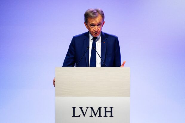 (FILES) Head of top luxury conglomerate LVMH Bernard Arnault presents the group's 2024 annual results in Paris, on January 28, 2025. LVMH will propose at its annual general meeting to raise the CEO retirement age from 80 to 85, allowing Bernard Arnault, 76, to remain at the helm of the world's leading luxury goods company for longer. (Photo by Dimitar DILKOFF / AFP)