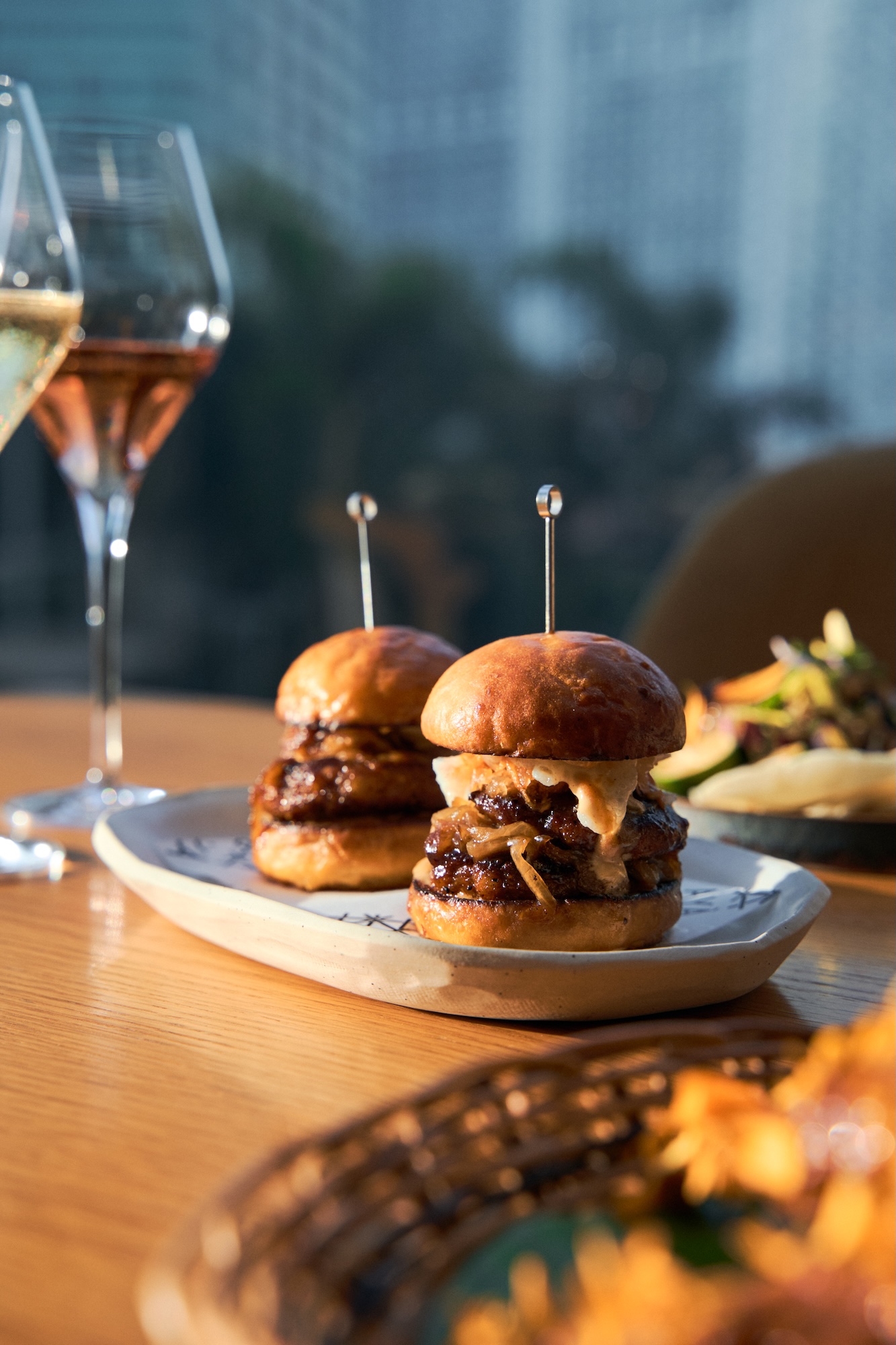 Smashed chori burger (homemade chorizo negrense, tocino glaze,atchara, caramelized onions, kamote milk buns)