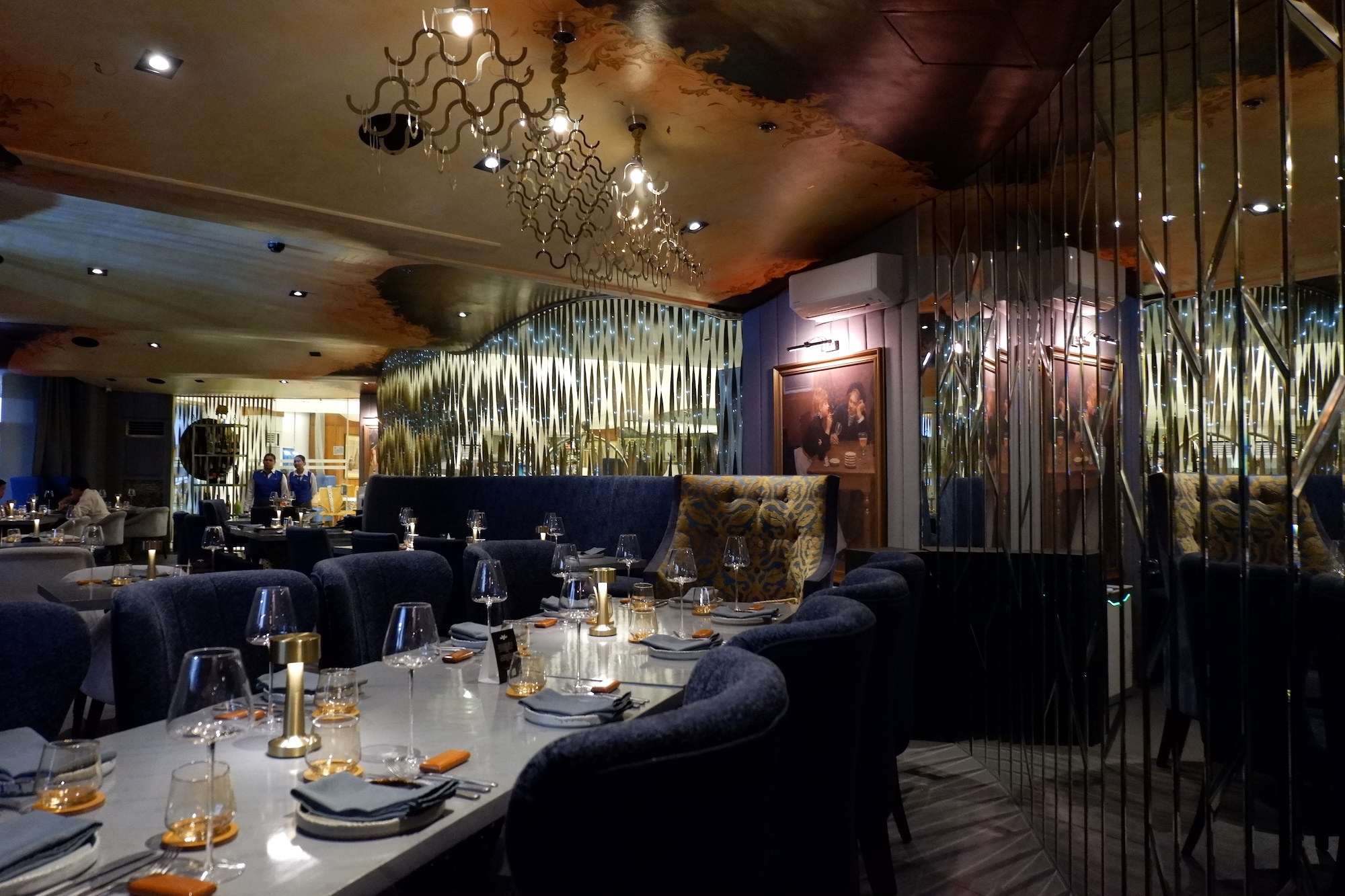 The interiors give the feeling of an oversized jewel box accented by the original Gina Bocar ceiling art