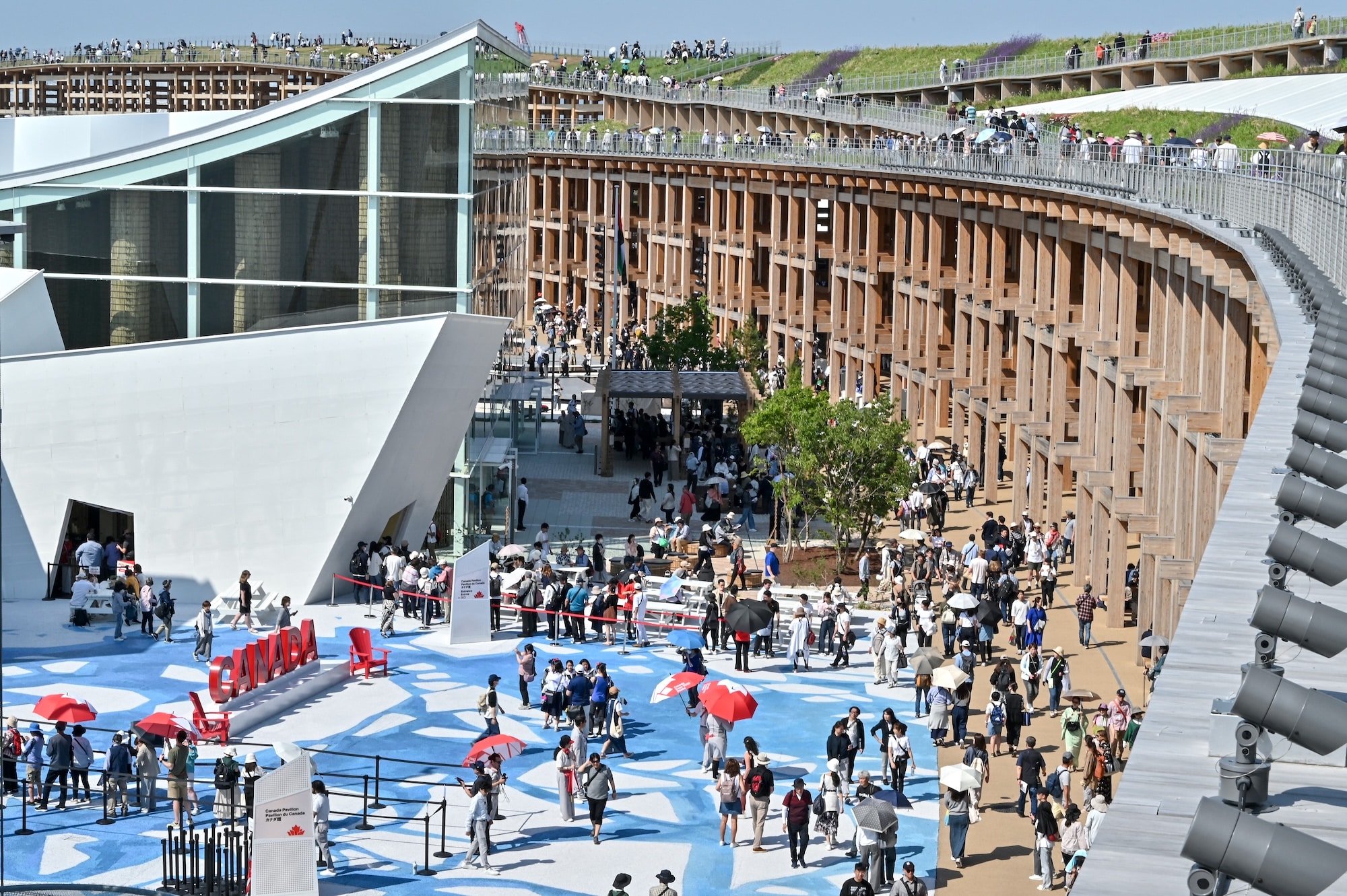 This general view shows people outside the Canada pavilion (L) as they visit the 2025 Osaka Expo in Osaka on May 14, 2025 | Photo by Richard A. Brooks/AFP
