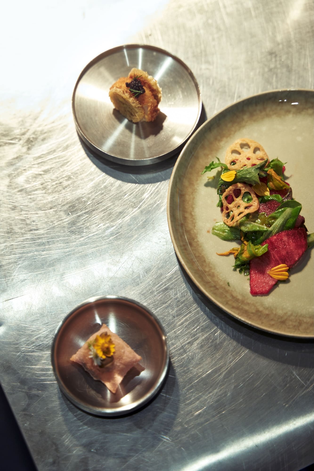 A couple of the appetizers next to the pear salad | Photo by JL Javier