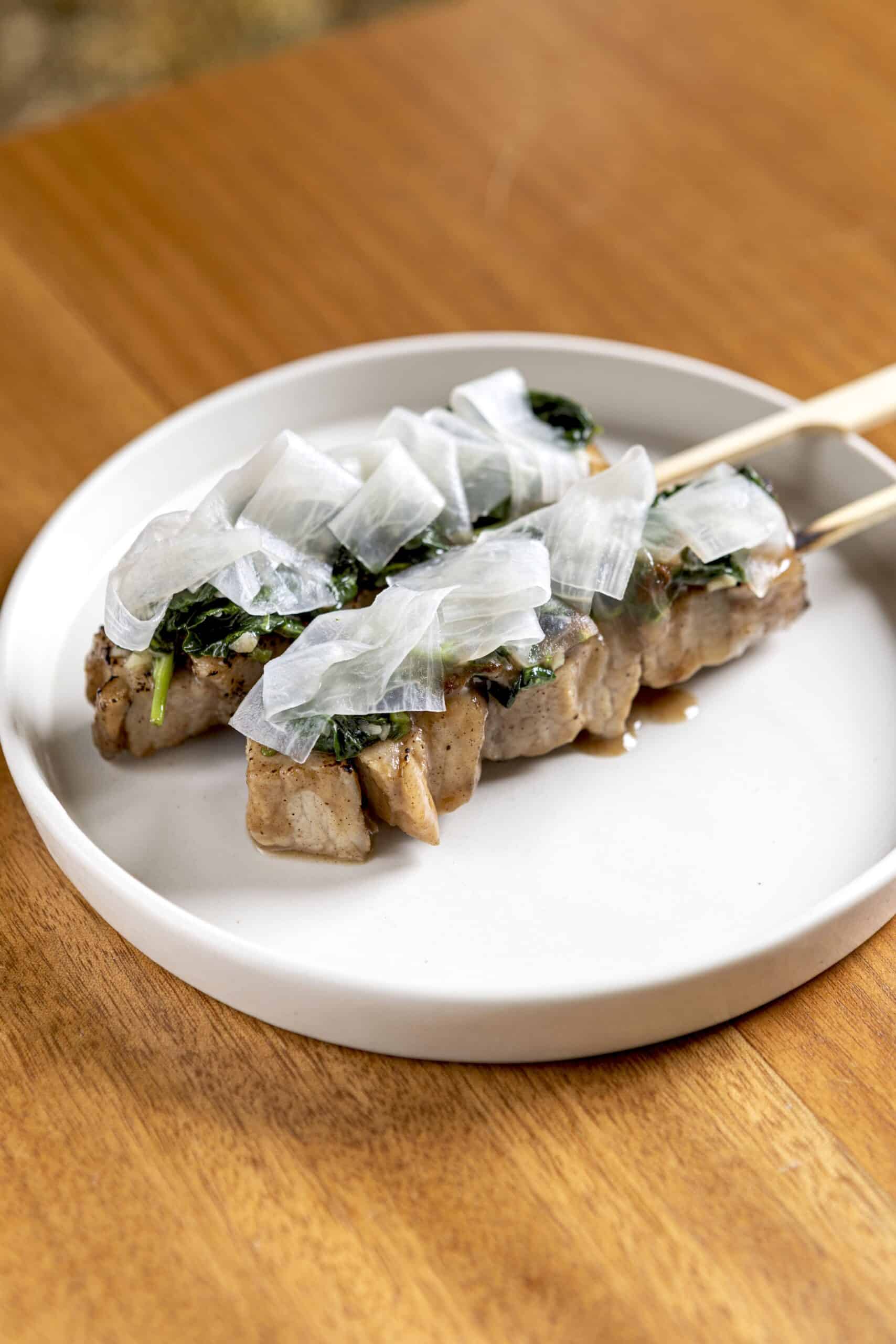 Pork sinigang skewers (roast pork belly, sinigang glaze, sautéed kangkong, pickled radish)